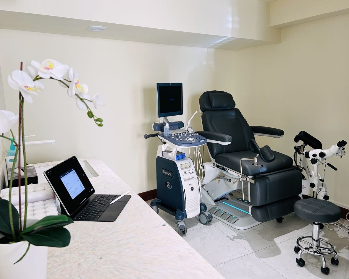Examination room at the centre: chair, ultrasound scanner and orchid