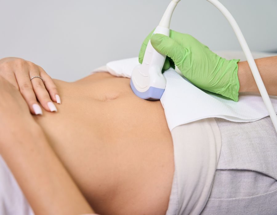 Pelvic ultrasound performed by a gloved doctor