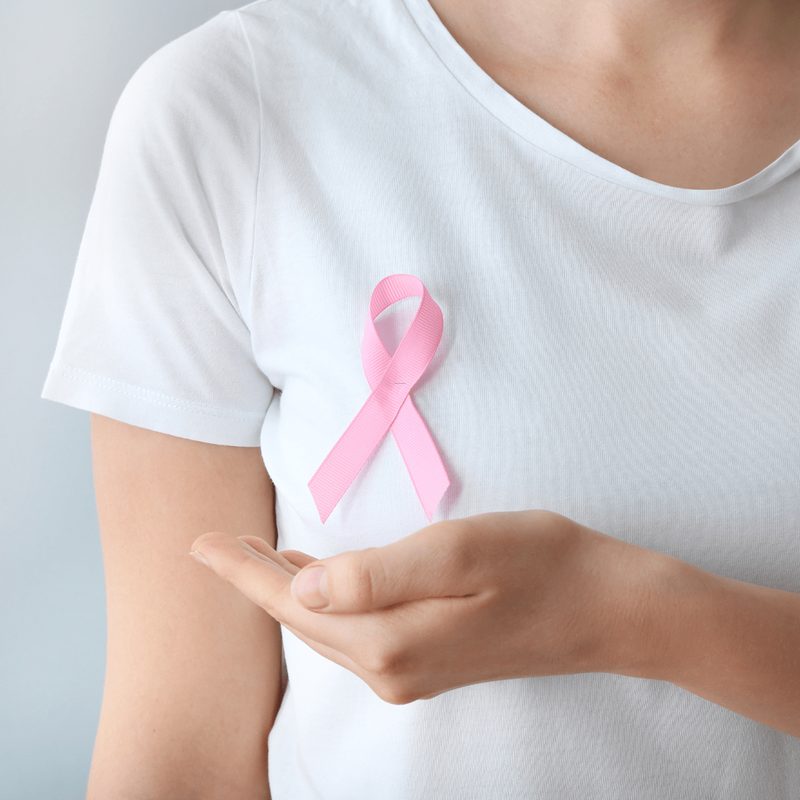 Woman wearing a pink ribbon, symbol of the fight against breast cancer