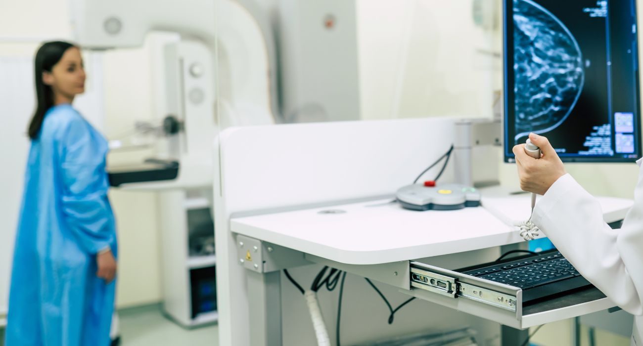 Mammography room: a radiographer prepares the machine